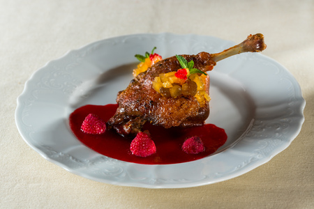 chicken foot with cranberry sauce with orange and raspberry berriesの写真素材