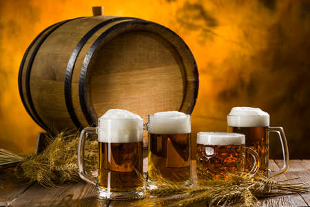 Barrel with glasses of light beer on a wooden tableの写真素材