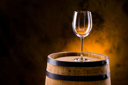 transparent empty glass of wine on a barrelの写真素材