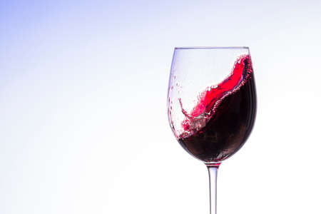 wine splashes in glasses isolated on white backgroundの写真素材