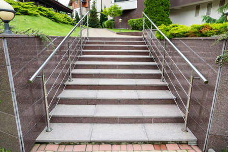 steps made of granite and marble in landscape design with railing