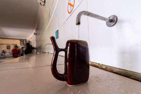 Water is poured into a special cup in the pump room of mineral waters,