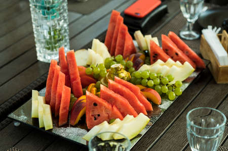 grape melon watermelon banana fruit on the tableの写真素材