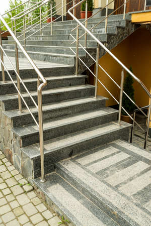 metal railings on the steps of the entrance group in the street outside