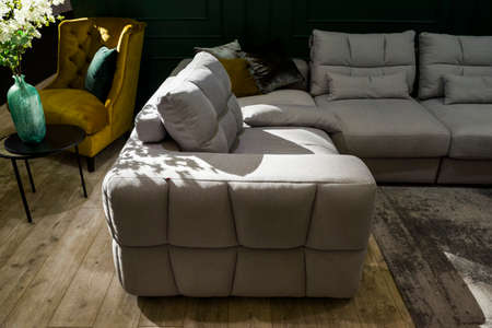 armchair and corner sofa in the interior on a sunny day