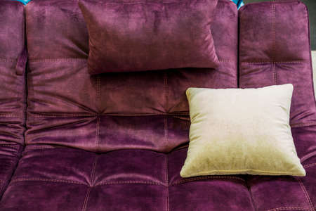 different textures of upholstery fabric on cushions for a sofa, a pillow on the sofa, an element of decor in the interiorの写真素材