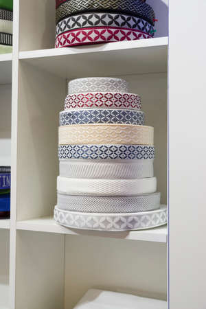 colored textil ribbons and embroidery on the shelves