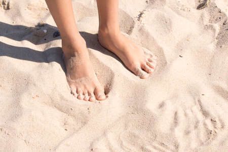 child's feet in the sandの写真素材