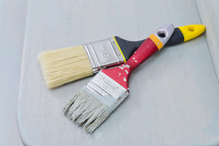 two brushes on the freshly painted surface