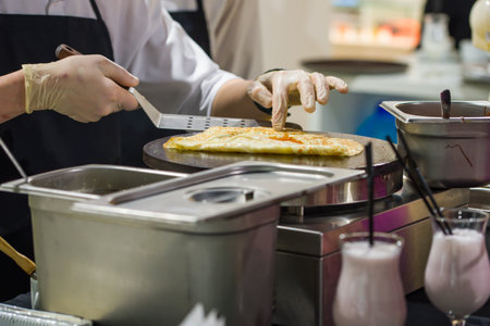 The cook prepares pancakes on the plateの写真素材