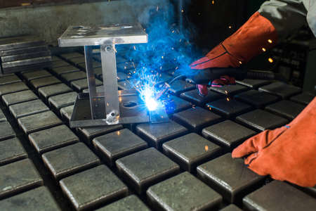 welder in the shop welds detail
