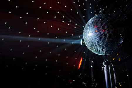 mirror ball with light beams, club light musicの写真素材