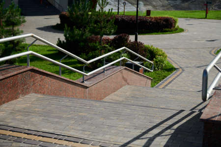 green bushes in landscape design, landscaping in the park outdoors, hanging flowers in tubsの写真素材