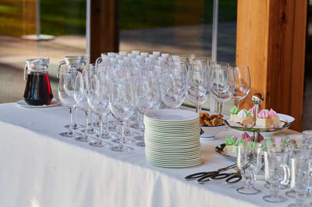 wine glasses on a catering table for receiving guests at an event in a restaurantの写真素材
