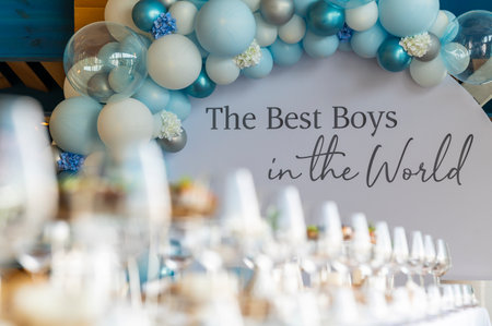 A photo zone with balloons and an inscription to the best boy in the world set up in a restaurant on a holidayの写真素材