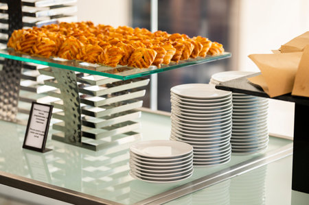 White plates stacked on a catering table at a reception eventの写真素材