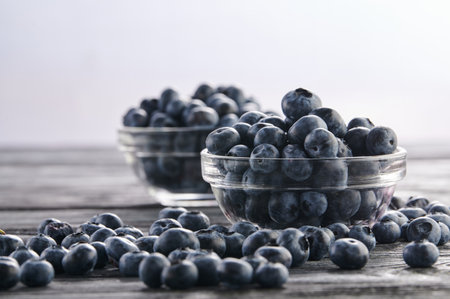 fresh blueberries in bowls on the tableの写真素材