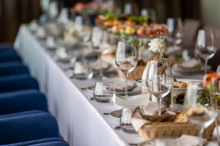 served table in a restaurant for receiving guests, serving dishes for visitors at a holiday at a large tableの写真素材