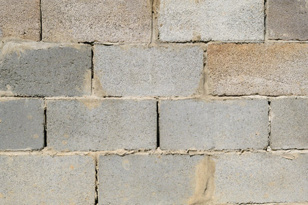 Laying a wall of gas blocks, building a building, fencing the territory, shot close-up