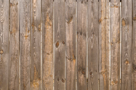 wooden fence made of unpainted boards, old territory fencing, close-upの写真素材