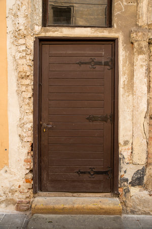 wooden doors with metal inserts and hinges, large part of the building as an element of architecture largeの写真素材