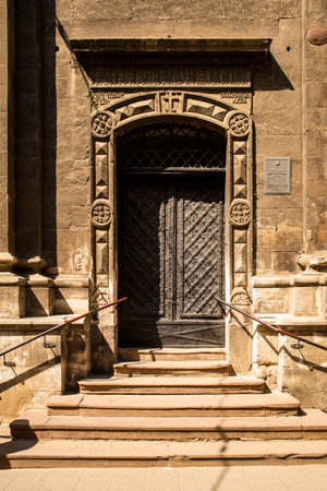 Entrance street carved wooden doors with metal inserts and hinges, large part of the building as an element of architecture largeの写真素材