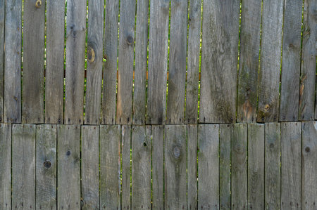 wooden fence made of unpainted boards, old territory fencing, close-upの写真素材