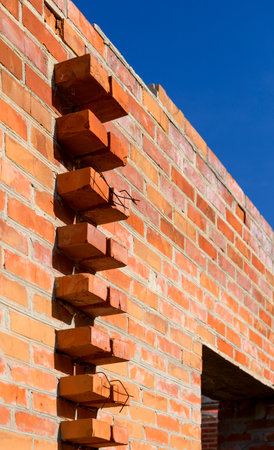Brickwork wall made of the bricks, construction of a building on the territory, shot close-upの写真素材