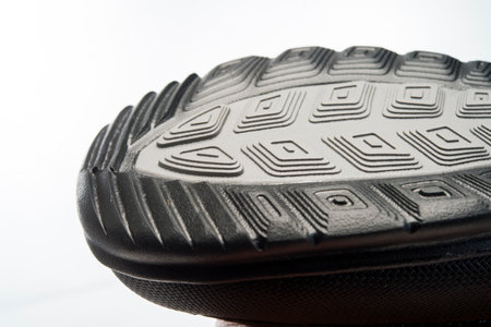 sole of a new boot with a grooved thread, shot close-up, object isolated on a white backgroundの写真素材