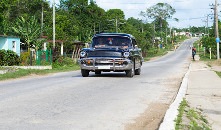 Cuba street with classic car drives in the countryside in Cienfuegosのeditorial素材