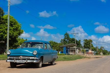 Blue american vintage car parked on the side from the Main Street to Santa Clara - Cuba Series Reportのeditorial素材