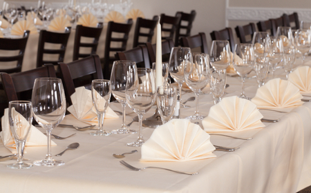 Festive table arrangement with glasses and served and cutleryの写真素材