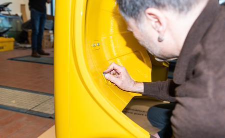 Car mechanic screws car parts together again after restoration - Serie Repair Workshopの写真素材