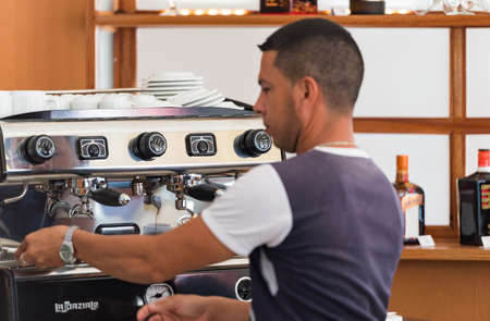 Cuban waiter prepares an expresso for the tourists in Havana Cuba - Cuba Reportage seriesのeditorial素材