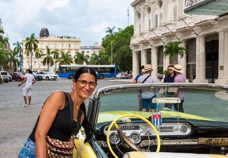 Interior view from a parked yellow 1955 Pontiac convertible classic car with a cuban model in the old town in Havana City Cuba - Serie Cuba Reportageのeditorial素材