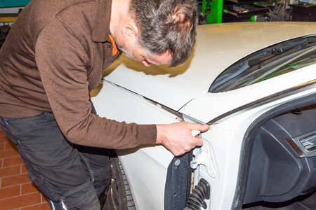 Car mechanic on the car - series car repair workshopのeditorial素材