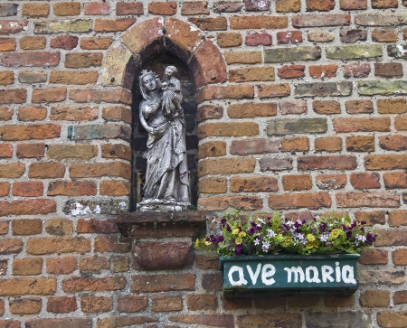 A statuette of the Virgin Mary in a wall niche  Bruges, Belgium の写真素材
