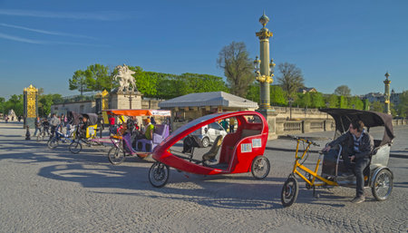 Bicycle taxi awaiting passengers  Paris, near the gates of the Tuileries Gardens