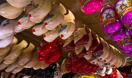 Rows of the traditional Dutch wooden shoes klomps under the ceiling of the souvenur shop in the tourist village of Zaanse Schans near Amsterdam.の写真素材