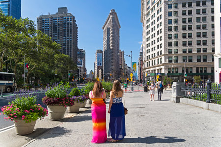 NEW YORK CITY - AUGUST 20, 2017: New York, Manhattan. Tourists on Fifth Avenue take pictures of the...
