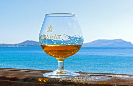 NOVYY SVET, CRIMEA - SEPTEMBER 2, 2017: A glass of cognac on the background of the sea. Novyy Svet, Crimea. Sunny day.のeditorial素材