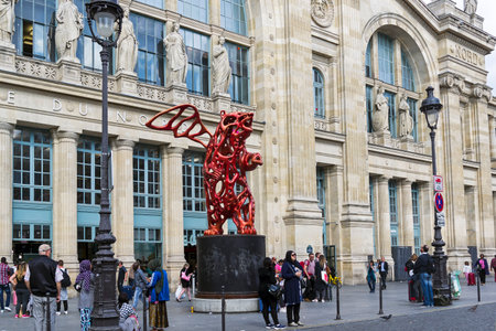 Paris, France - August 31, 2018: The statue of a red winged bear in front of the North Station (Gare du Nord) in Paris.のeditorial素材