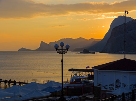 Sunset twilight on the sea. View from the embankment of the resort town of Sudak, Crimea. September.のeditorial素材