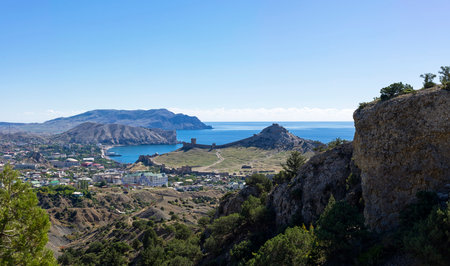 View of the resort town of Sudak and the medieval Genoese fortress from a mountain slope. Crimea....