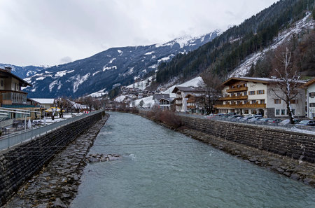 Zell am Ziller, Austria, March 11, 2019: River Ziller flowing through the ski resort Zell am Ziller. Tyrol, Austria. Cloudy day in March.のeditorial素材