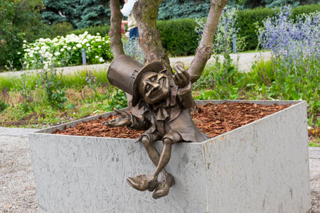 Moscow, Russia - July 6, 2018: Bronze figure of a leprechaun at the root of a tree - Garden sculpture at Moscow Flower Show.のeditorial素材