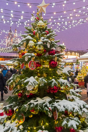 Moscow, Russia - January 2, 2019: The annual Journey to Christmas  Festival. Snow-covered Christmas tree at the fairground on Revolution Square.のeditorial素材