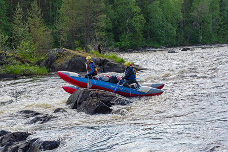 Karelia, Russia - June 24, 2019: Tourist catamaran in a difficult and dangerous situation. Varatsky...