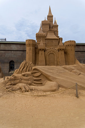 Saint Petersburg, Russia - June 13, 2019: The exhibition of sand sculptures at the Peter and Paul Fortress. Composition with a dragon guarding the entrance to a fairytale castle..のeditorial素材