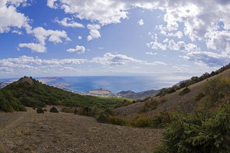 View from the top of Mount Perchem to the Black Sea coast near the resort town of Sudak, Crimea. Sunny day in September.の写真素材